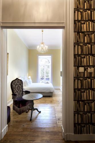 a bedroom with a bed and a book shelf with books at Casa do Principe in Lisbon