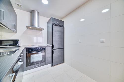 a kitchen with a stove and a refrigerator at Apartamento Oihana by Clabao in Huarte