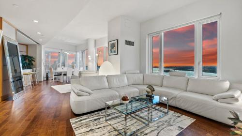 a living room with a white couch and a table at Luxurious 4 BR Penthouse in NYC in New York