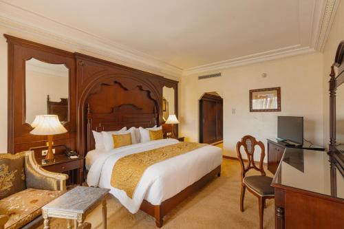 A bed or beds in a room at Grand Mogador Agdal & Spa