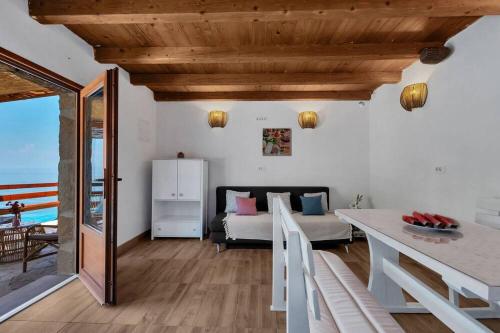 a living room with a bed and a table at Holiday Home -Didina in Sućuraj