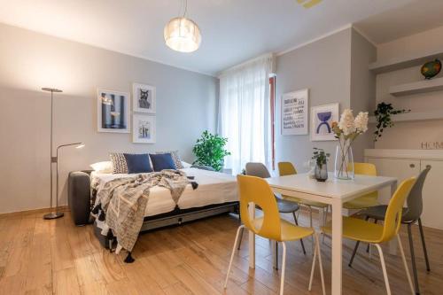 1 dormitorio con 1 cama, mesa y sillas en Ginger-Appartamento a due passi dal centro con posto auto - Porta Romana en Siena