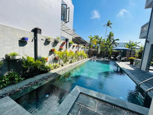 a swimming pool in front of a building at De Mai’s apartment in Hoi An