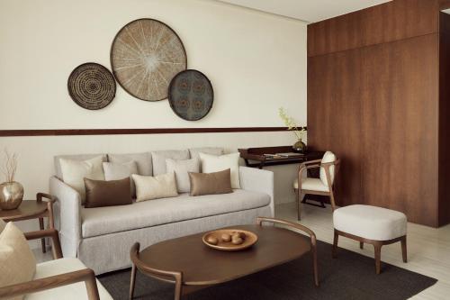 a living room with a couch and a table at Mare Paphos in Paphos