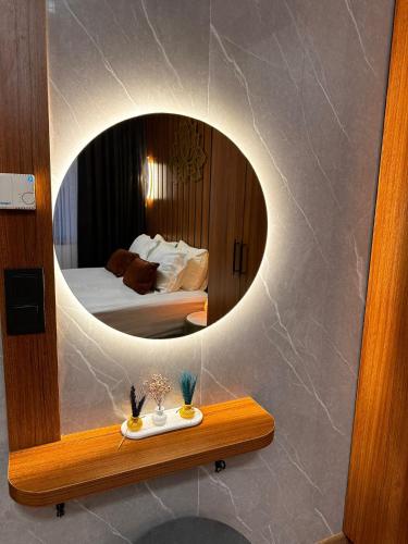 a bathroom with a mirror and a bed in a room at SABİHA GOKCEN İSTANBUL HOUSES Airport in Istanbul