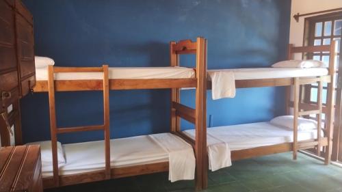 a group of bunk beds in a room at Morro Hostel e Pousada in Morro de São Paulo