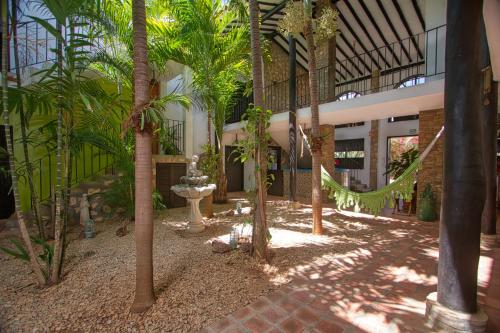 a courtyard with palm trees in a building at Playa El YAQUE Posada Yaque Sol, Isla de Margarita in El Yaque
