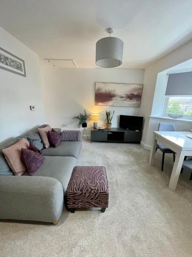 a living room with a couch and a table at Compact Modern Apartment Single Person or Couple Only in Bangor