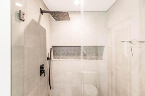 a bathroom with a shower with a glass door at Waterfront Home with Pool Minutes to Sanibel in Fort Myers