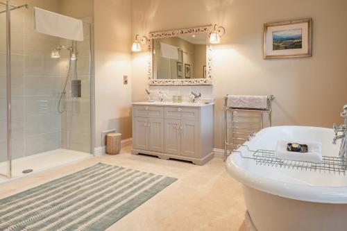 a bathroom with a toilet and a shower and a sink at Milton Lodge - Seasgair Lodges in Newtonmore