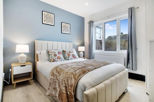 a bedroom with a large bed and a window at Appealing 4-Bedroom Haven in Durham, Sleeps 7 in Durham