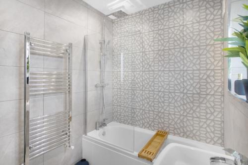 a bathroom with a shower and a tub and a sink at Appealing 4-Bedroom Haven in Durham, Sleeps 7 in Durham