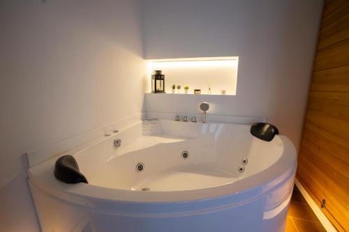 a white bath tub in a bathroom with a mirror at Luxury Moscatell 15 in Novelda