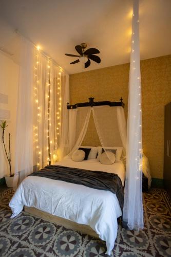 a bedroom with a bed with a ceiling fan and lights at Luxury Moscatell 15 in Novelda