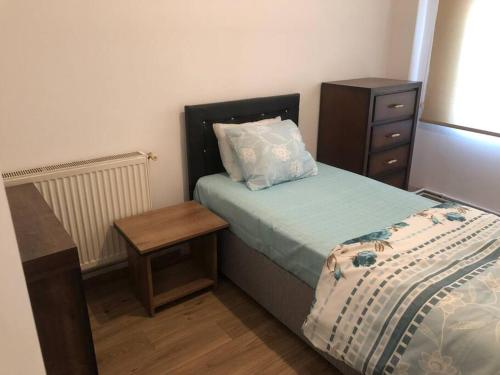 a small bedroom with a bed and a night stand at Beyoğlu/Taksim are also in a perfect location in Istanbul