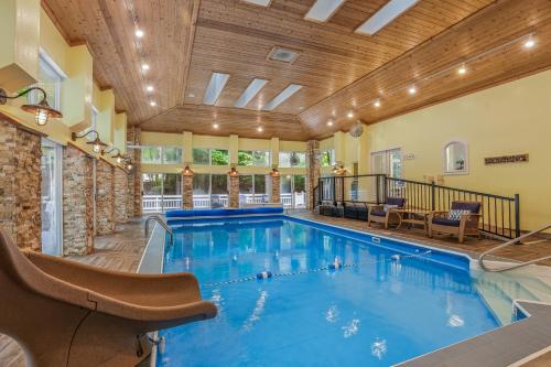 a large indoor pool with a wooden ceiling at Indoor Pool near Grand Haven with Lake Michigan Beach! in Norton Shores