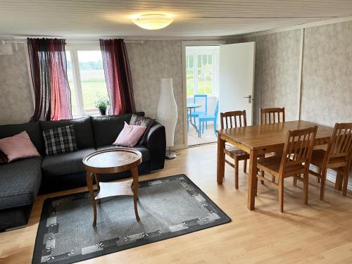 a living room with a couch and a table at Nice cottage located close to a bay in Skappevik in Bergkvara