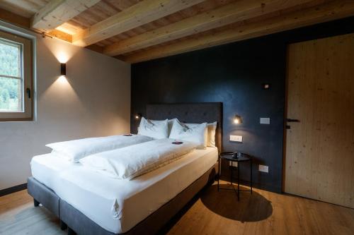 um quarto com uma grande cama branca e uma janela em Sun Villa Genf with Spa em Livigno