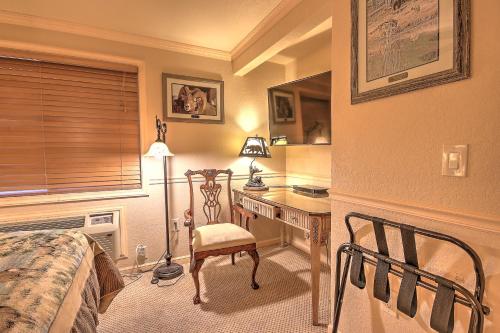 a bedroom with a desk and a bed and a desk with a chair at Yellowstone Gateway Inn in Gardiner