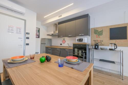 a kitchen with a wooden table with bowls on it at BergamoCityCenter 03 in Bergamo