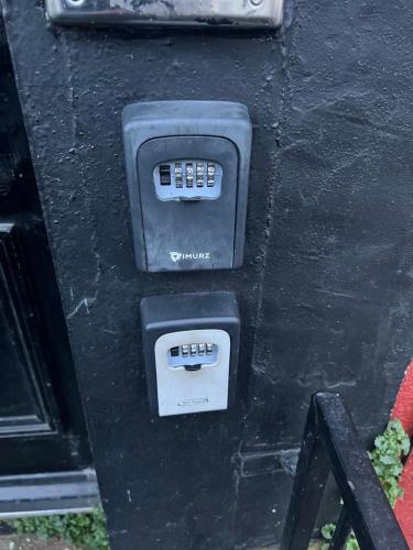 an electronic device with two controls on a wall at Cosy central apartment near Stokes Croft in Bristol