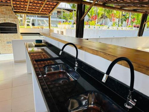 a sink with two faucets on a counter at Villa Simone in Natal