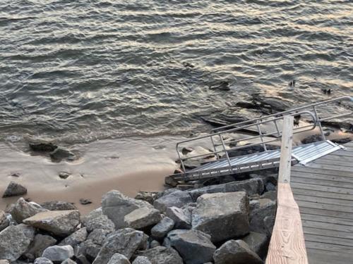 a boat sitting on a dock next to the water at Indoor Pool near Grand Haven with Lake Michigan Beach! in Norton Shores