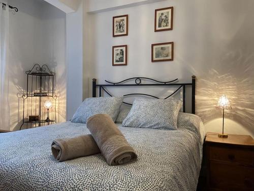 a bed with a rolled up towel on top of it at Los Angeles House in Sopelana
