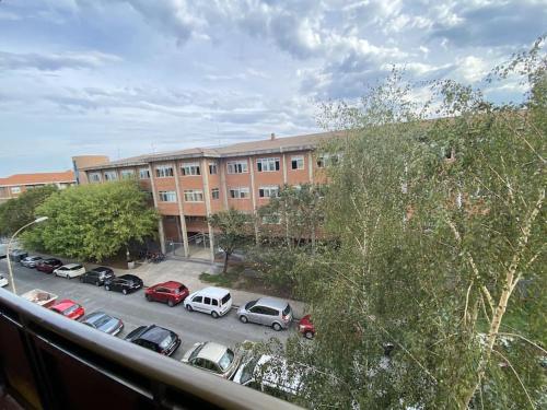 a parking lot with cars parked in front of a building at Los Angeles House in Sopelana
