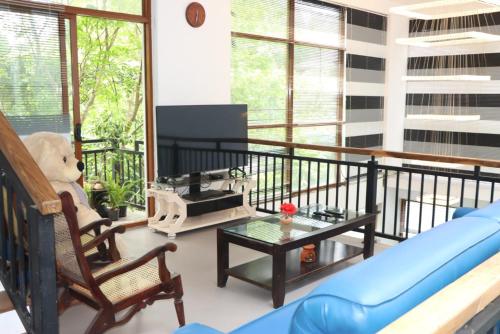 a living room with a blue couch and a table at Gampaha Heritage in Gampaha