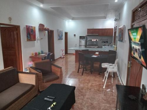 a living room with a kitchen and a dining room at Lovina Vibes Hotel in Balian