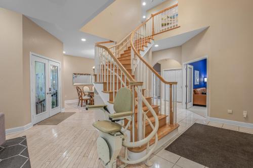 a spiral staircase in a home with a living room at Indoor Pool near Grand Haven with Lake Michigan Beach! in Norton Shores