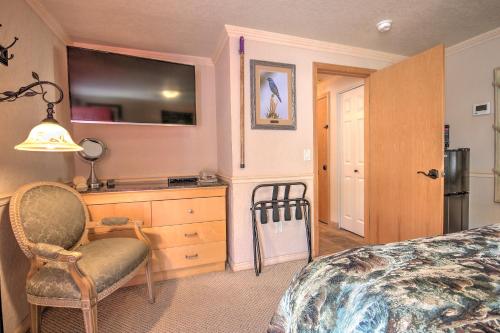 a bedroom with a bed and a chair and a dresser at Yellowstone Gateway Inn in Gardiner