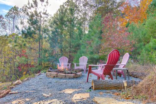 three chairs and a table in a fire pit at 7 Mi to Lake Lure Mill Spring Cabin with Hot Tub in Mill Spring