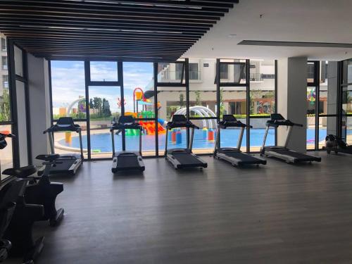 a gym with a bunch of treadmills and a pool at K Avenue Seaview Nearby Kota Kinabalu Airport in Kota Kinabalu