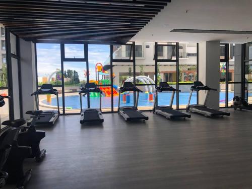 a gym with a bunch of treadmills and a pool at K Avenue Seaview Nearby Kota Kinabalu Airport Free Car Park & Water Filter in Kota Kinabalu