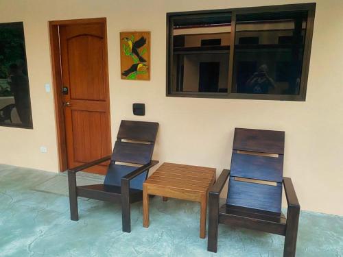 two chairs and a wooden table in a room at Brahman Bungalows on Pavones Point in Pavones
