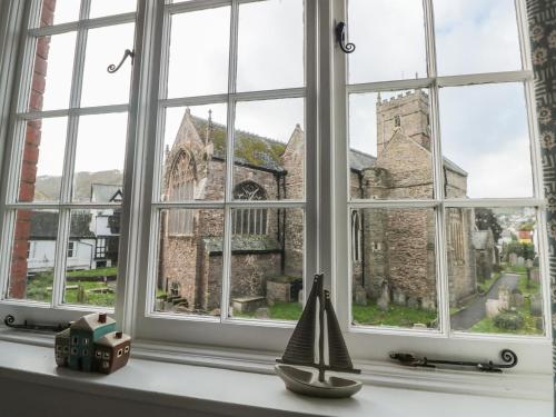 a window with a view of a church at Quayside in Dartmouth