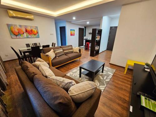 a living room with a couch and a table at Lovely Vivacity Jazz 2 Cozy Condo 2 Card LV11B in Kuching