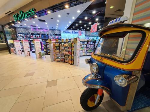 a small motor bike parked in a store at Lovely Vivacity Jazz 2 Cozy Condo 2 Card LV11B in Kuching