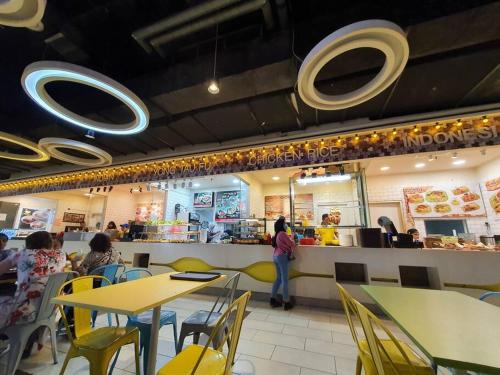a restaurant with tables and people sitting at a counter at Lovely Vivacity Jazz 2 Cozy Condo 2 Card LV11B in Kuching