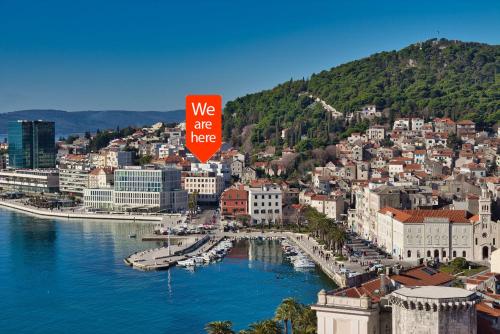 a city with a sign that says we are here at Bepo Studio Apartment - FREE PARKING in Split