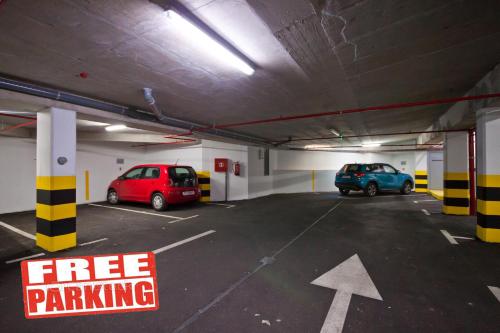 a parking garage with two cars parked in it at Bepo Studio Apartment - FREE PARKING in Split
