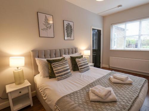 a bedroom with a bed with two towels on it at The Pheasantry in Bridlington