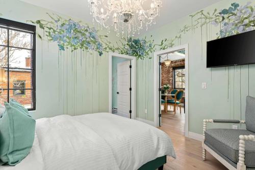 a bedroom with a bed and a chandelier at The Acoma House in Denver