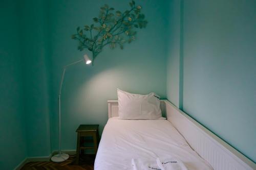 a bed in a room with a blue wall at FLH Alcântara Stylish Duplex with Terrace in Lisbon