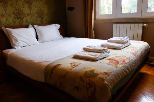 a bed with towels stacked on top of it at FLH Alcântara Stylish Duplex with Terrace in Lisbon