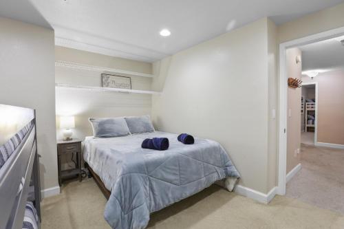 a bedroom with a bed with blue pillows on it at Indoor Pool near Grand Haven with Lake Michigan Beach! in Norton Shores