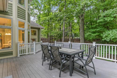 a deck with a table and chairs on a house at Indoor Pool near Grand Haven with Lake Michigan Beach! in Norton Shores