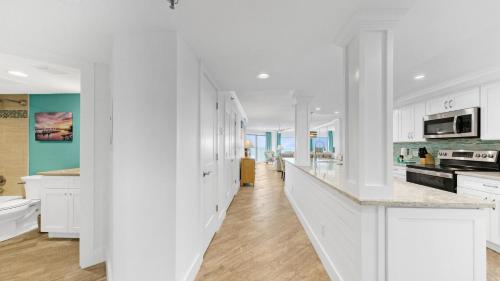a kitchen with white cabinets and a white counter top at Inlet Reef 607 - Beach Front and Spacious with Free Beach Service in Destin